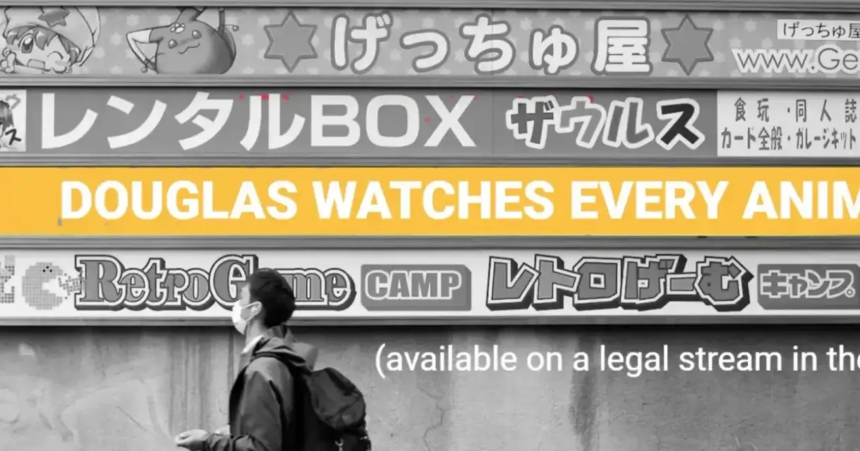 A black and white photograph of a man in a sterile mask, walking past a series of horizontal advert panels. One of the panels says, in white text on a yellow background, "Douglas Watches Every Anime". Underneath that is the white text, "(available to stream in the UK)