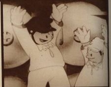 A sepia cartoon image. In front of a pair of torpedo tub seals, two figures in Japanese navy uniform throw their gloved hands in the air in celebration.